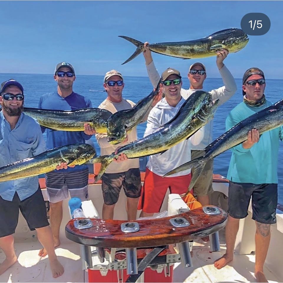 Fishing group with fresh mahi-mahi catch on a sport fishing boat in Jacó, Costa Rica — private chef can cook your catch in the villa