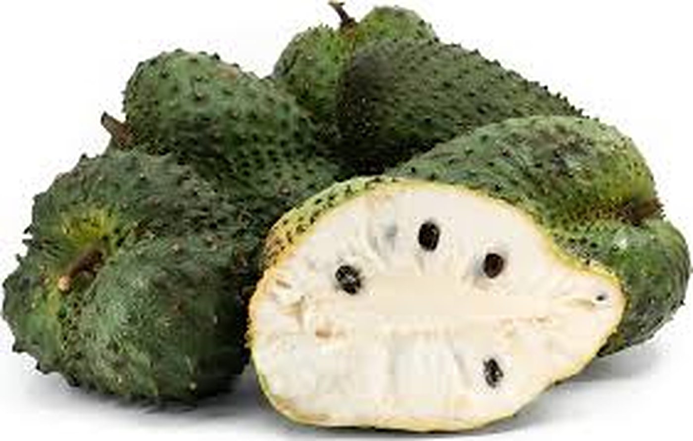 A guanabana (soursop) sliced open showing soft white pulp and shiny black seeds