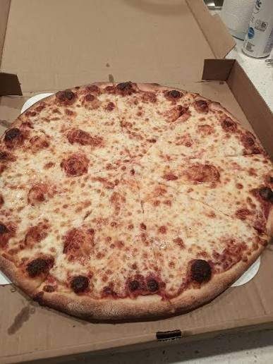 Cheese pizza in an open delivery box from Pizza Luciano's in Jacó