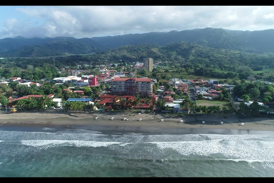 Aerial of Playa Jacó and Hotel Cocal with the mountains behind