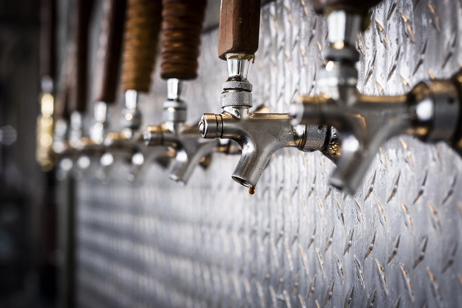 Row of beer taps at PuddleFish Brewery