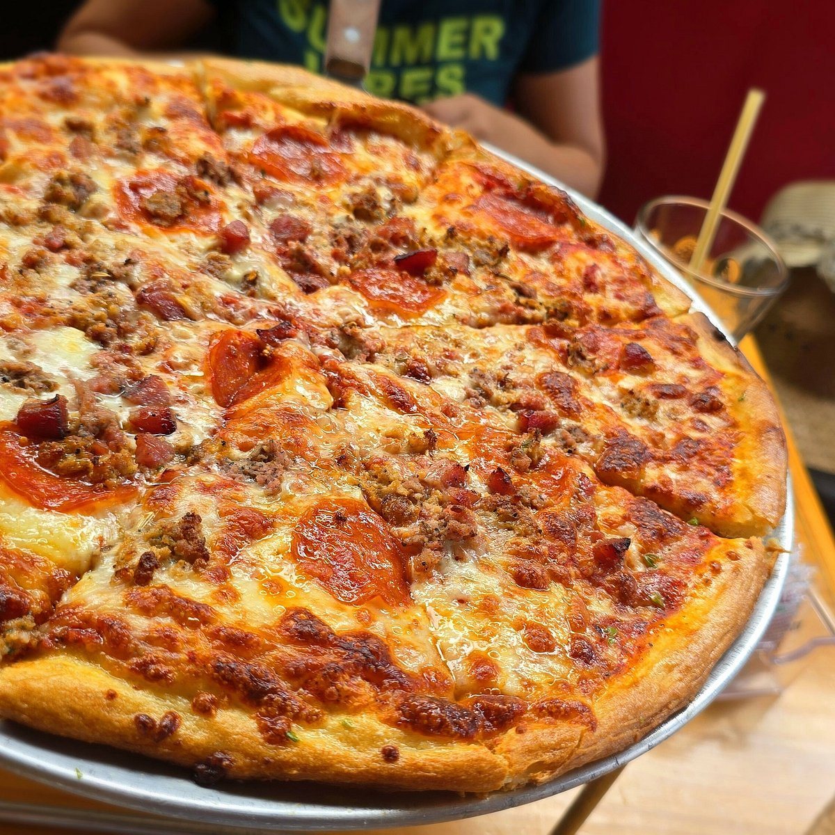 Loaded meat New York-style pie at The Pizza Shop in Jacó