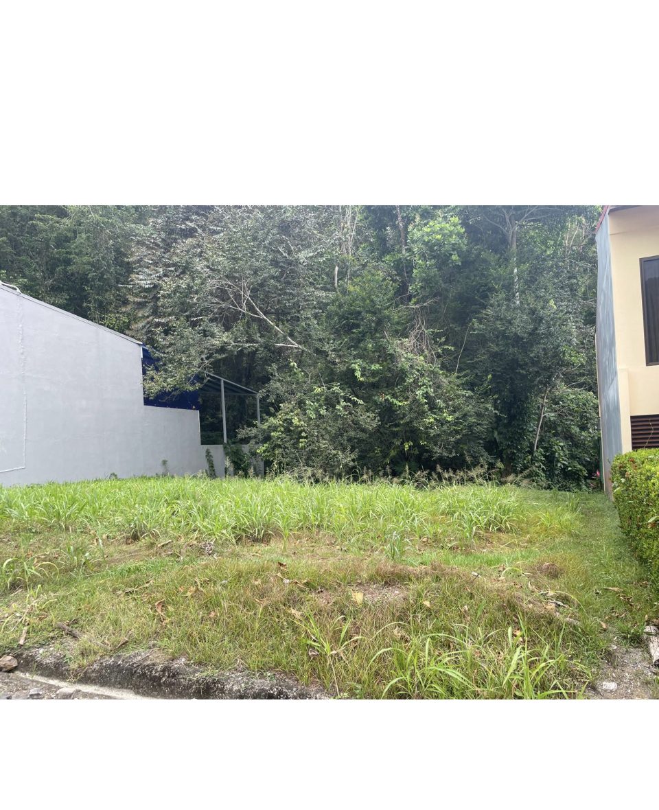A finished two-story home beside the building lot in a gated Punta Leona community — best properties near Jaco Beach, Costa Rica