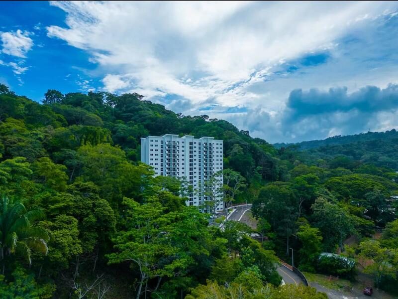 Luxury residential building rising from green rainforest at Playa Blanca, Punta Leona — Jaco Beach real estate, best properties near Jaco Beach