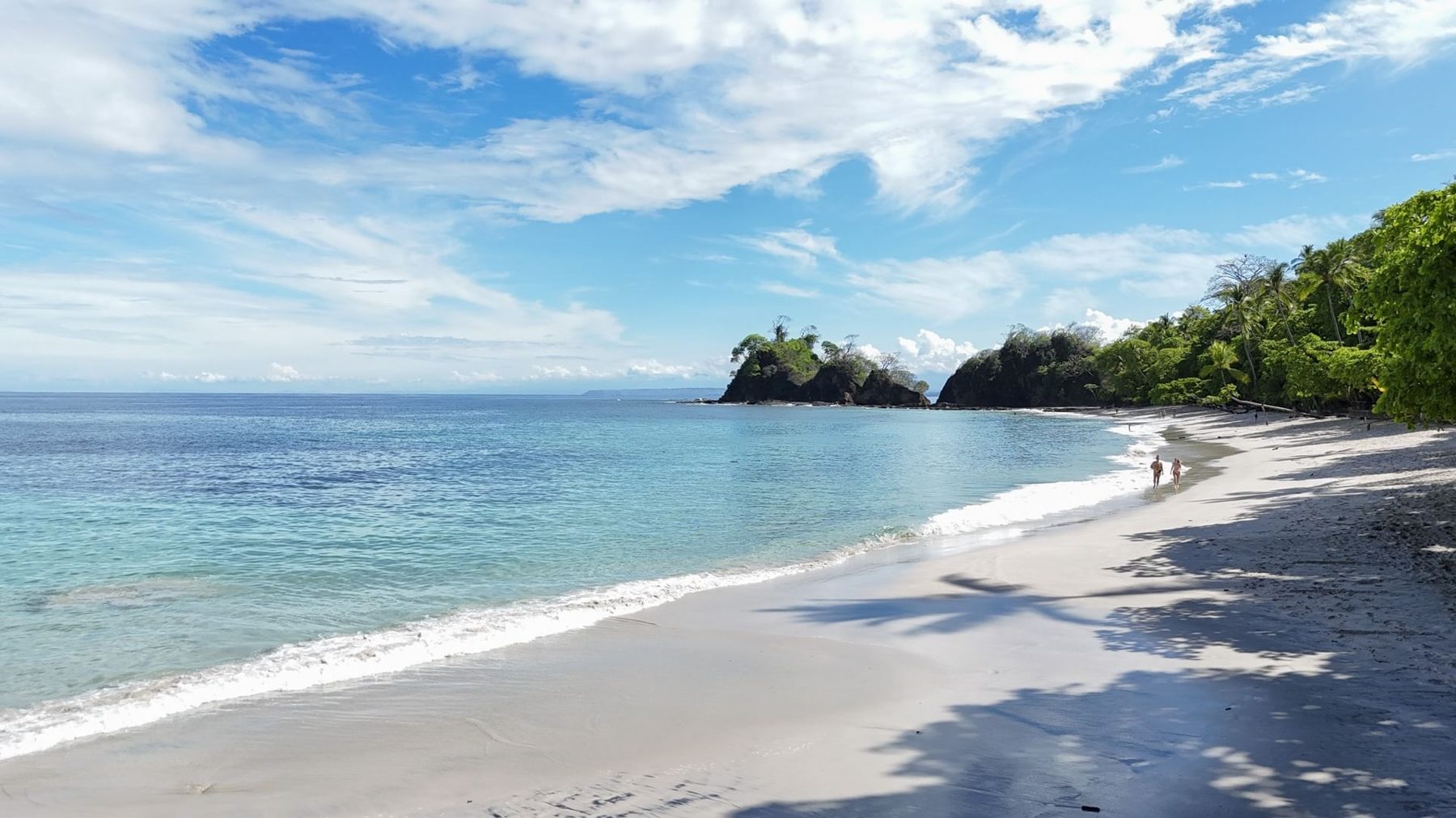 White-sand beach with calm turquoise water at Playa Blanca near Punta Leona — best places to buy near Jaco Beach, Costa Rica