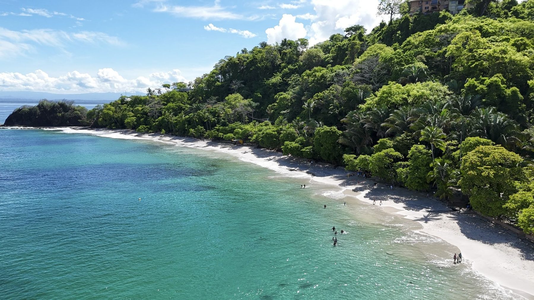 Forested headland and white-sand beach at Punta Leona near Jaco — real estate Jaco, best priced real estate near Jaco