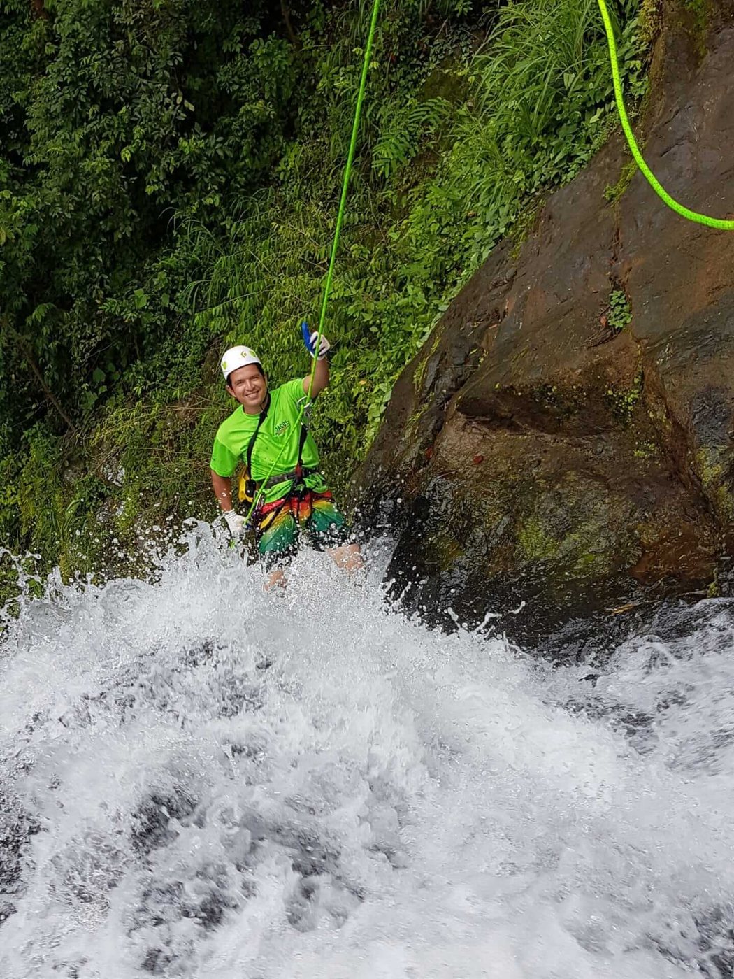 Rappelling into the whitewater at the base of a falls