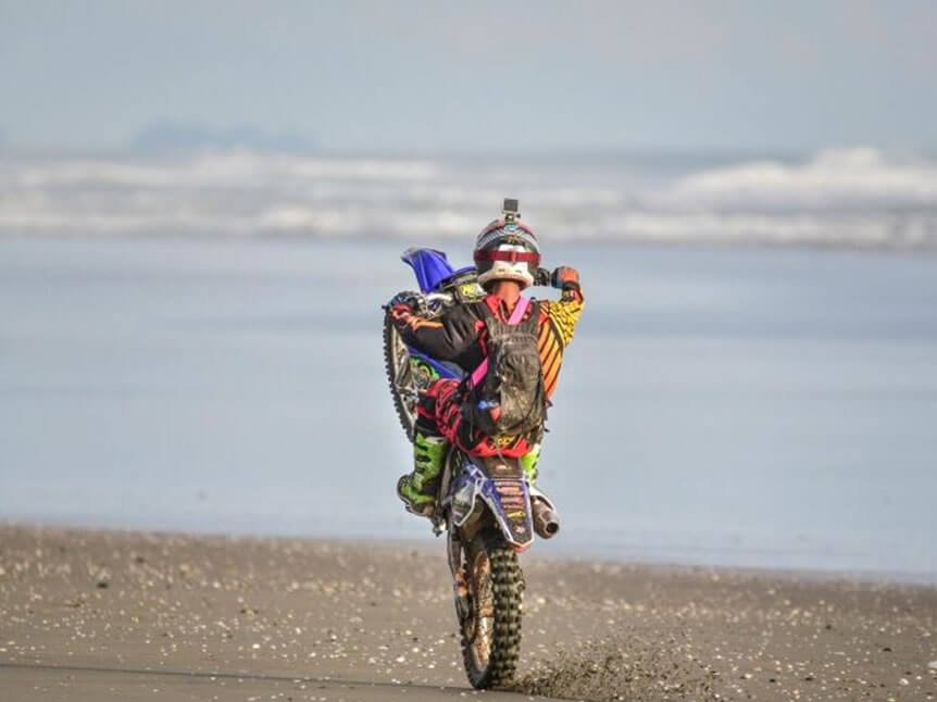 Enduro rider on a misty Pacific beach