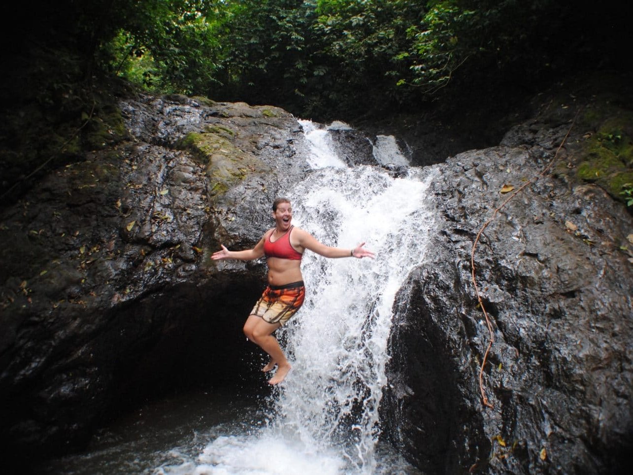 Guest cooling off at the base of a waterfall