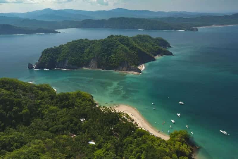 Aerial view of Tortuga Island's turquoise bay and white-sand beach